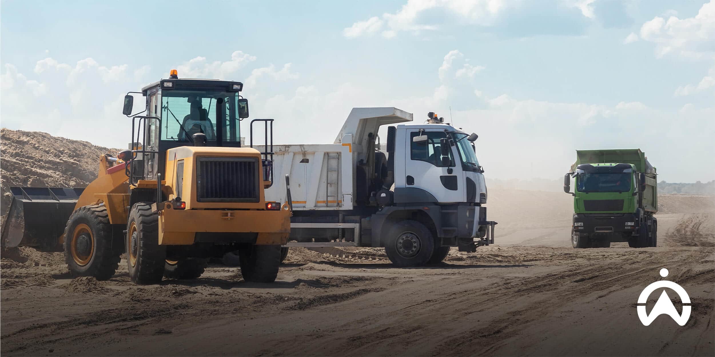 Heavy equipment fleet tracking on a construction site with loader and dump trucks.